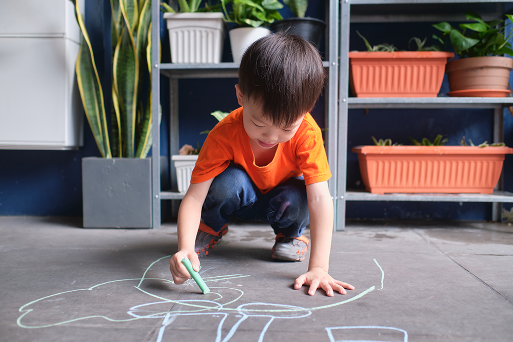 Child playing on the ground with germs